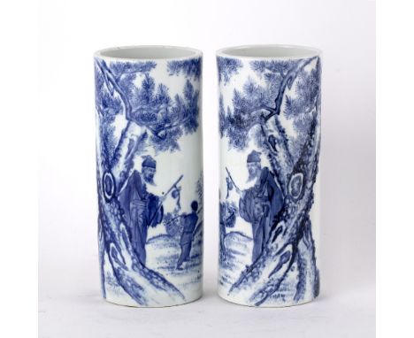 Pair of blue and white porcelain sleeve vases Chinese each painted with a lohan and boy carrying a wicker basket, having seal