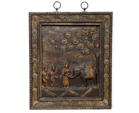 Repoussé copper votive plaque Nepalese, 19th Century depicting an elephant with its elaborate trappings standing underneath a