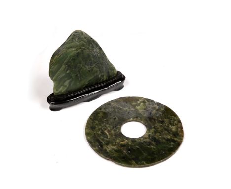 Spinach jade bi disc Chinese of archaic form, 15cm and a hardstone scholars piece in the form of a mountain, 11.5cm high (2)