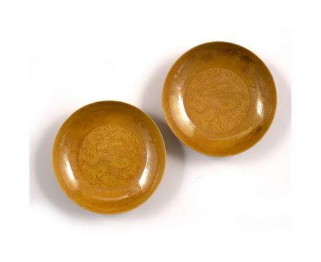 Yellow glazed saucer dishes Chinese, Kangxi period decorated with plain rounded sides within which is a central medallion del