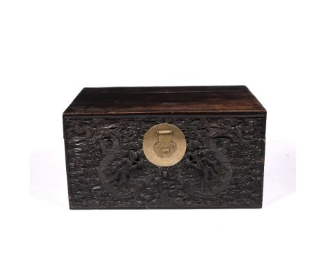 Carved trunk Chinese, 19th Century the front with heavy original brass lock, and brass carrying handles, and with raised drag