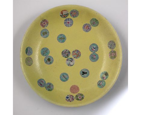Yellow ground charger Chinese, 19th Century decorated to the centre with Buddhist emblems depicting various object, the rever