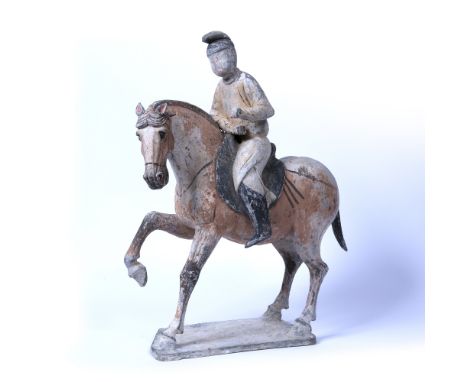 Ceramic horse and rider Chinese, Tang Dynasty, 618-906 AD the horse advancing with one foreleg raised, painted bridle and har