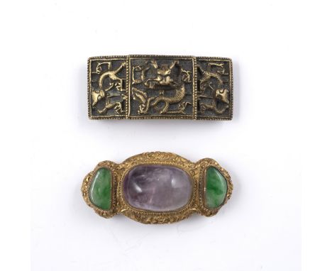 Two belt buckles Chinese the first with gold metal backing with two inlaid jade coloured stones and a central stone, 7cm acro