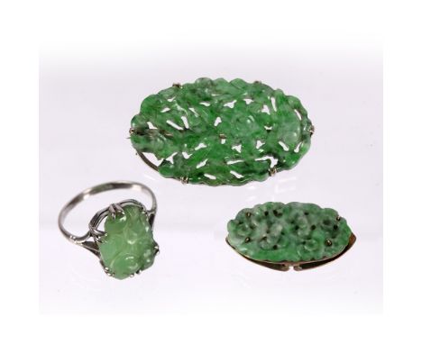 Jade reticulated brooch Chinese, 1920-1930 apple green and oval form, a spring-loaded dress clip with oval apple green jade p