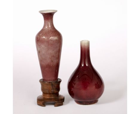 Sang de boeuf small bottle vase Chinese, 19th Century 13cm high and a Chinese tapering plum blossom vase, in a later wood sta