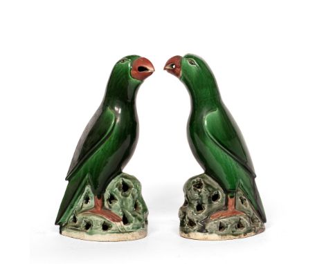 Pair of porcelain models of green glazed parrots Chinese, 19th Century Kangxi-style with black eyes, red painted beaks and cl