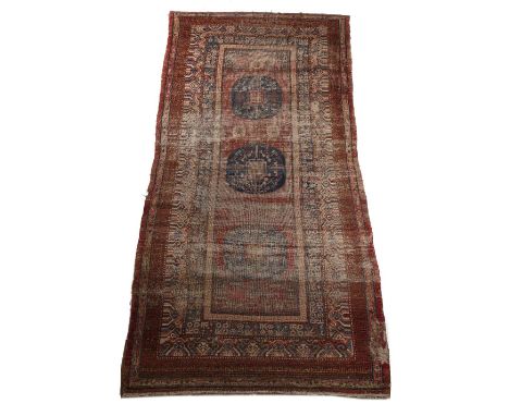 Khotan large rug Chinese the red ground rug with natural dyes having a central panel with three blue medallions, 360cm x 176c