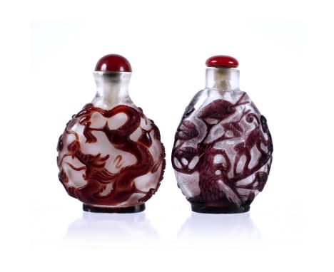 Ruby red overlay snuff bottle Chinese 19th Century dragon and phoenix with red stopper, 7.5cm high and a Chinese, 19th Centur