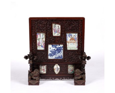 Table screen with inset panels Chinese, 19th Century with central square blue and white porcelain panel depicting an equestri