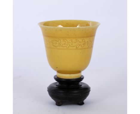 Yellow glazed cupChinesewith incised decoration around the neck of the cup, six character Kangxi mark to base, with a wooden 
