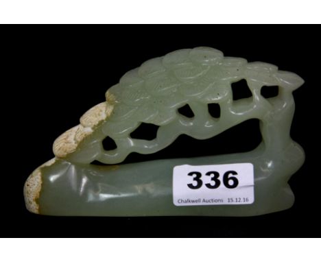 A Chinese carved jade natural form brush rest, W. 13cm, H. 8cm.