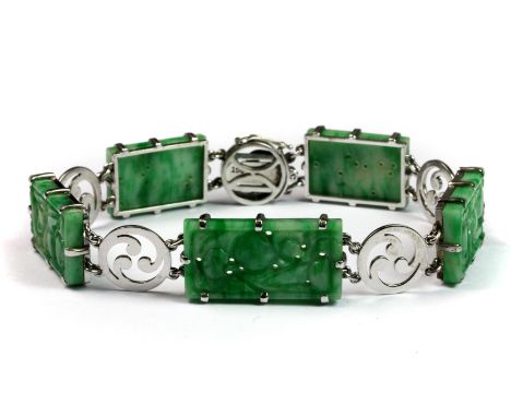 A lovely 9ct white gold mounted (stamped 9ct) carved jade bracelet, L. 19cm.