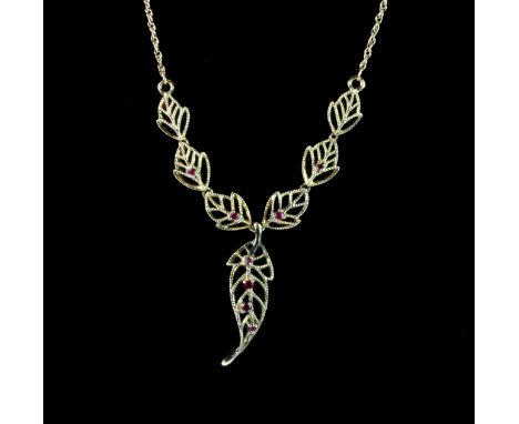A 10ct yellow gold (stamped 10K) ruby set leaf necklace.
