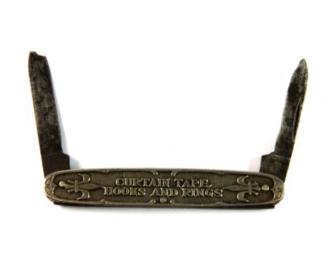 A vintage Rufflette "Curtain tape, hooks and rings" advertising pocket knife.