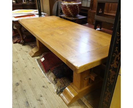 A 17th century style oak refectory table, on stout end supports joined by a stretcher, and with sledge feet, 220 cm wide

Rep