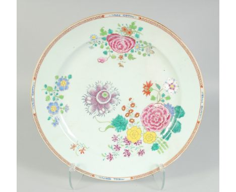 A CHINESE FAMILLE ROSE PORCELAIN CHARGER, finely enamel painted with native flora and gilt highlights, 40.5cm diameter.