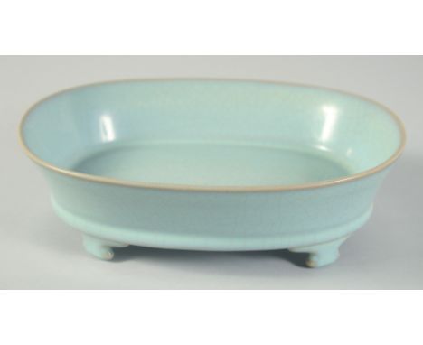 A CHINESE CELADON CRACKLE GLAZE PLANTER, raised on four feet, 22.5cm x 17cm.