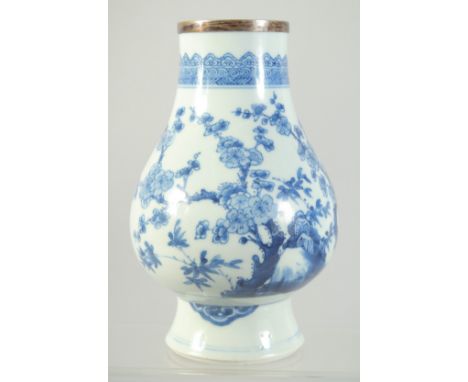 A CHINESE TRANSITIONAL BLUE AND WHITE PORCELAIN VASE, painted with flora, (neck cut with silver rim cap), 18cm high.