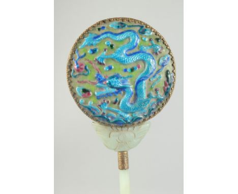 A CHINESE ENAMEL AND JADE MOUNTED HAND MIRROR, the reverse decorated with relief enamelled dragon, 22cm long.