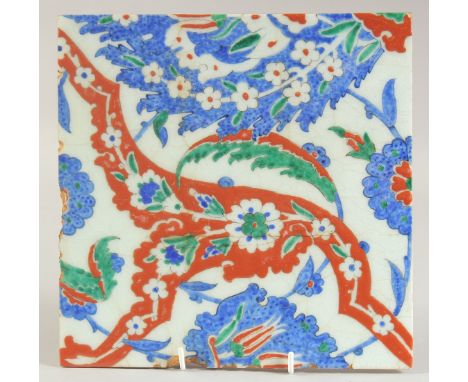 AN IZNIK GLAZED POTTERY TILE, with decorative floral sprays, 25cm square.