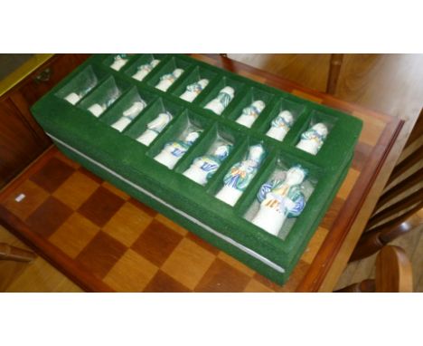 A modern chess set with ceramic pieces.