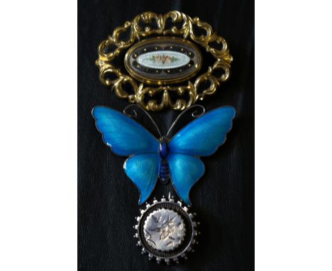 A blue enamel butterflyTogether with a Victorian white metal brooch and a Victorian sentimental brooch (3)