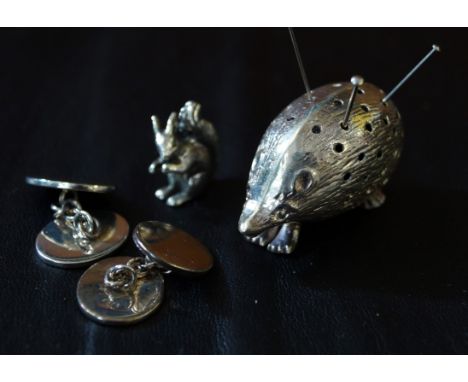 A silver hedgehog pin cushionTogether with, a silver squirrel ornament, a pair of silver cufflinks (3)