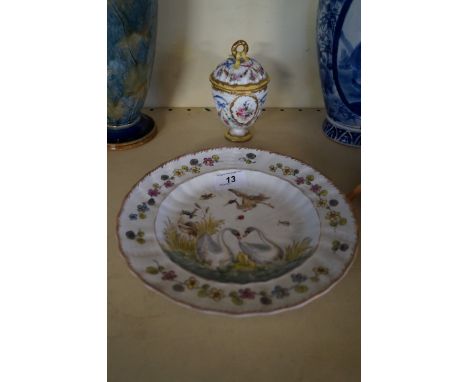 A Capodimonte porcelain plate with relief moulded floral decoration and scenes depicting herons, together with a continental 