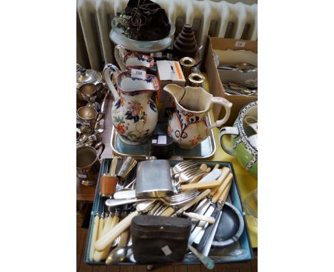 A mixed lot of assorted items to include silver-plated flatware, Victorian ceramic jugs, pair of Georgian brass candlesticks 