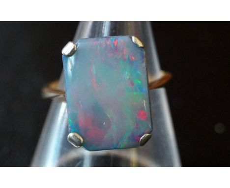 An opal doublet ringTo a yellow metal shank stamped 9ct, weight 3.6g