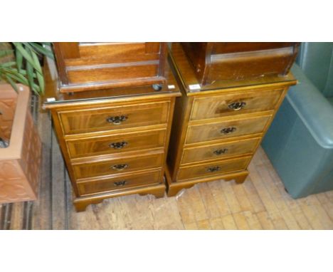 A pair of reproduction mahogany bedroom chests of four drawers, each raised on bracket supports.