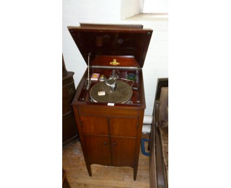 An early 20th Century mahogany Academy gramophone with two cupboard doors enclosing speaker grill.