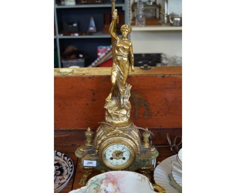 A reproduction gilt spelter figural mantel clock/lamp base modelled in the form of a classical maiden with her arm outstretch