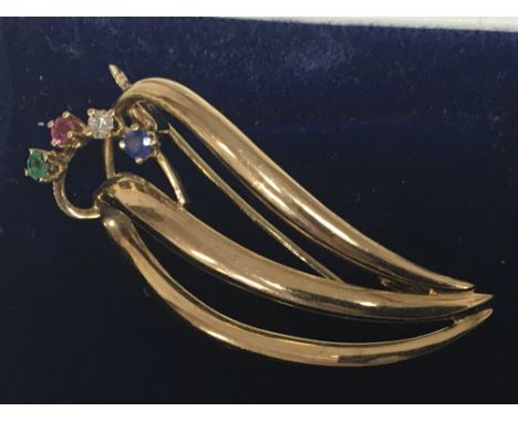 An unmarked gold brooch set with ruby sapphire and emerald and diamond. Weight 3.8g