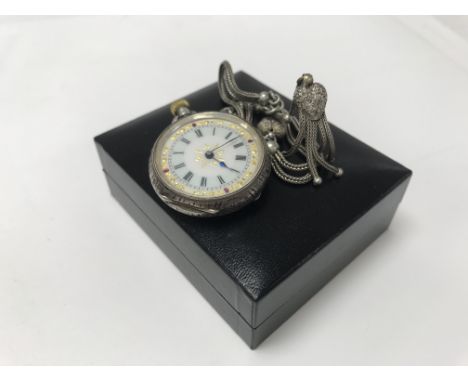 A Swiss silver cased button wind watch with attached watch chain.