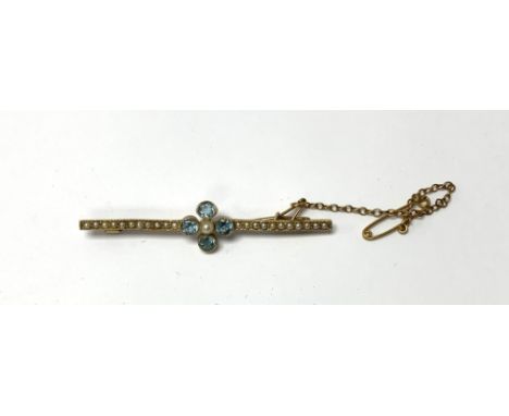A 15ct gold seed pearl and tourmaline bar brooch with gold safety chain. 3.7g, (A)
