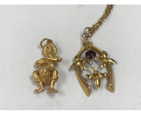 A 9 ct Edwardian pendant with attached chain together with a unmarked charm .