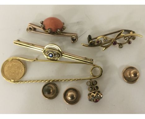 Four gold brooches one set with a Mexican 1945 gold coin studs and and an odd ruby and diamond earring. Total weight 18.5g