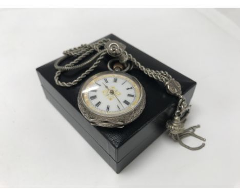 A Swiss silver cased button wind watch with attached watch chain.