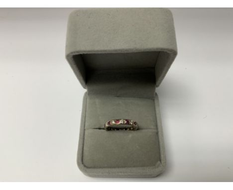 18ct white gold ruby and diamond set full eternity ring, Size Q. (Postage Catagory A).