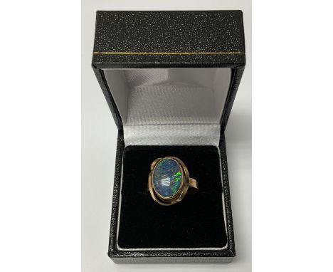 A 9ct gold and opal doublet ring, (Postage Catagory A).