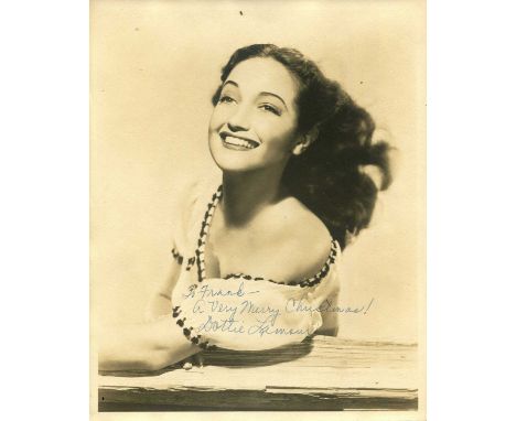 LAMOUR DOROTHY: (1914-1996) American actress. Vintage signed and inscribed sepia 8 x 10 photograph of the actress in a breezy