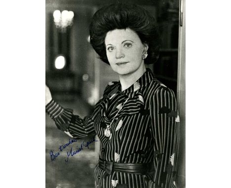 SPARK MURIEL: (1918-2006) Scottish novelist. Vintage signed 7 x 9 photograph of Spark standing in a half-length pose in a doo