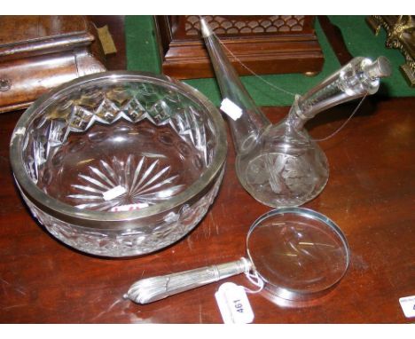 A silver rimmed bowl, oil decanter and magnifying glass