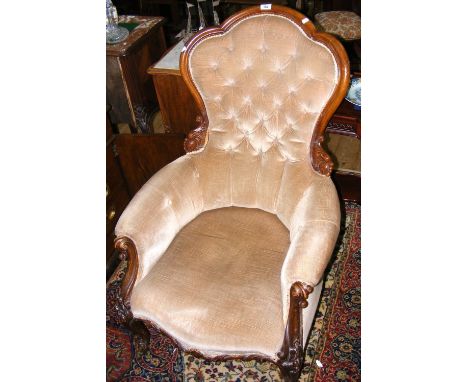 A Victorian button back easy chair with cabriole front supports