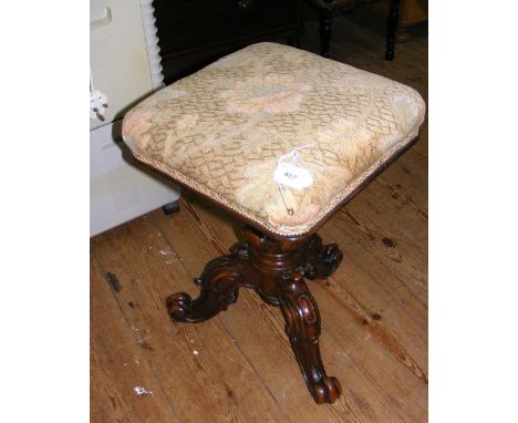 A Victorian revolving piano stool with tapestry top