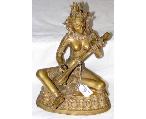Cast metal figure of deity playing musical instrument - 32cm high