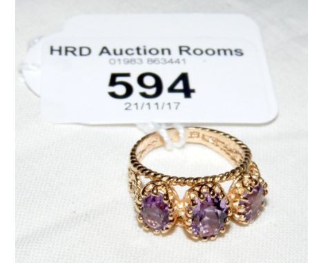 A three stone amethyst ring in 9ct gold setting