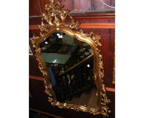 A decorative gilt framed wall mirror - 145cm x 80cm